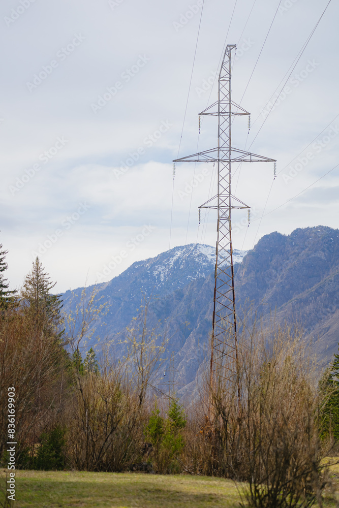 View of old power transmission towers in a mountainous area View of old power transmission towers in a mountainous area