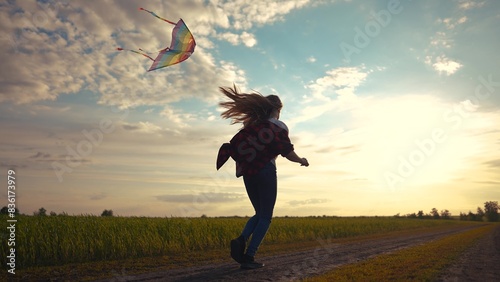 child girl run with a kite in the park. happy family freedom a kid dream concept. child daughter running with their backs at sunset in nature in the park holding a kite lifestyle playing glare