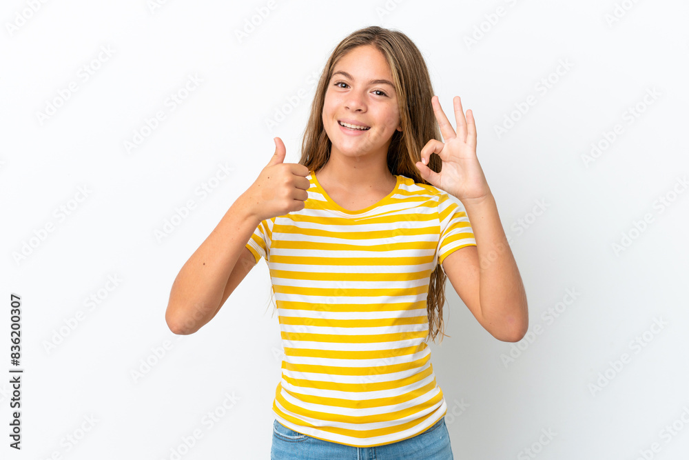 Little caucasian girl isolated on white background showing ok sign and thumb up gesture Little caucasian girl isolated on white background showing ok sign and thumb up gesture