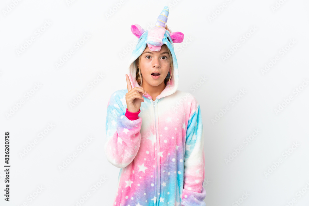Little girl with unicorn pajamas isolated on white background thinking an idea pointing the finger up Little girl with unicorn pajamas isolated on white background thinking an idea pointing the finger up