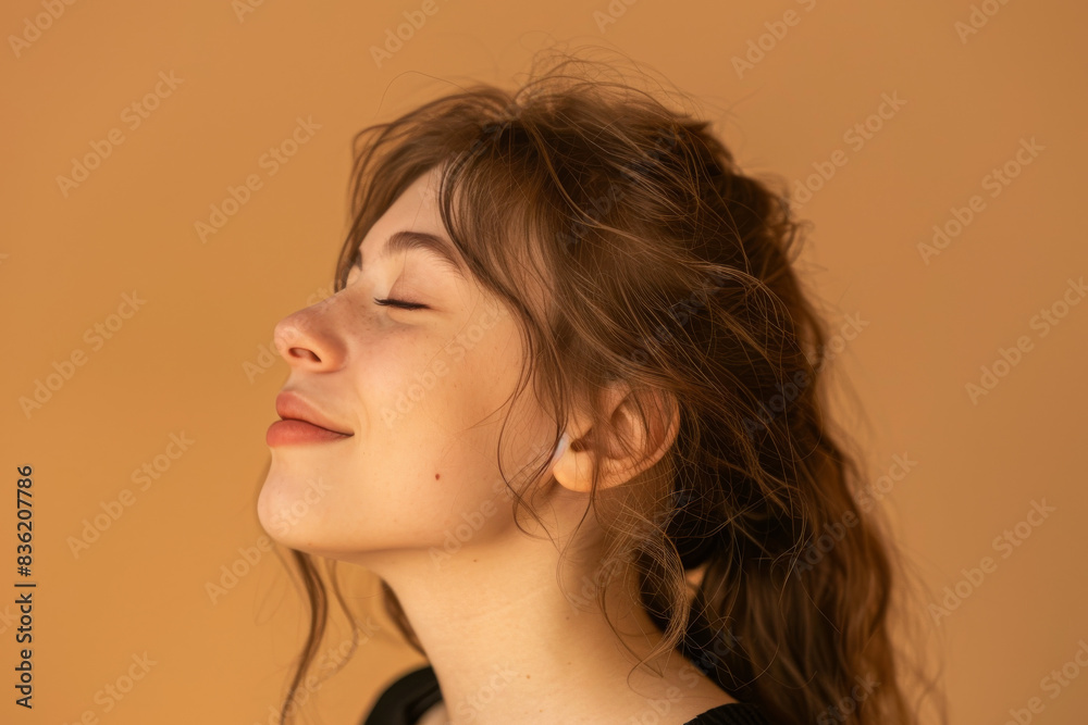 A close up of a woman's face with her eyes closed looking to a side A close up of a woman's face with her eyes closed looking to a side