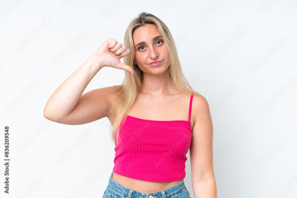 Young caucasian woman isolated on white background showing thumb down with negative expression Young caucasian woman isolated on white background showing thumb down with negative expression