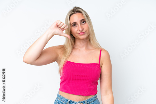 Young caucasian woman isolated on white background showing thumb down with negative expression © luismolinero