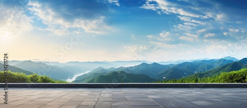 Fototapeta Naklejka Na Ścianę i Meble -  Panoramic view of natural scenery with an asphalt road and mountain range at sunrise, perfect for a copy space image.