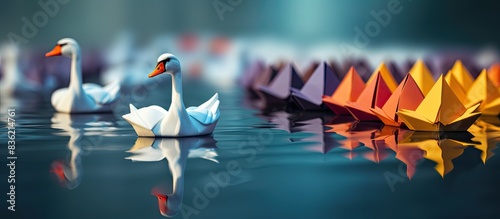 Fototapeta Naklejka Na Ścianę i Meble -  Paper origami swan and ducks on a blue background, showcasing a distinctive leadership concept with copy space image.