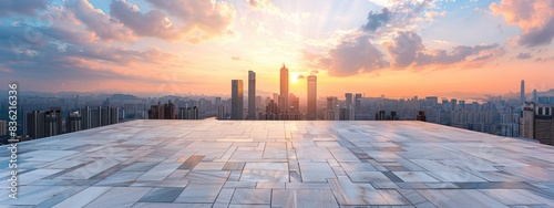 Empty square marble floor with city skyline and sky at sunset, panoramic view of urban architecture © grigoryepremyan