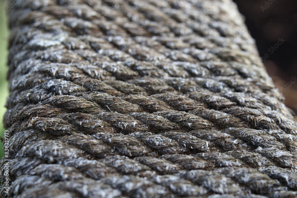 Rope wrapped around wood board. Abstract rope pattern. Perspective view of of rope, string, twine or cord wrapped in straight lines. Weathered outdoor maritime texture. Selective focus. Rope wrapped around wood board. Abstract rope pattern. Perspective view of of rope, string, twine or cord wrapped in straight lines. Weathered outdoor maritime texture. Selective focus.