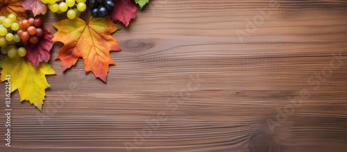 Vintage books with autumn leaves on a wooden surface with copy space image.