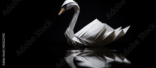 Fototapeta Naklejka Na Ścianę i Meble -  Rare black swan origami paper art on a white background with copy space image.