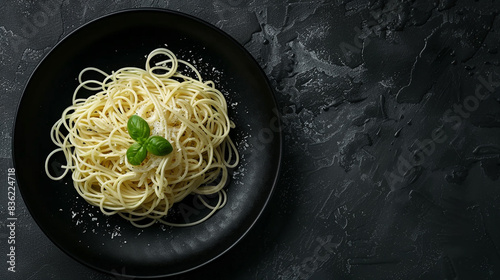 Dark plate with Italian spaghetti on a dark background.