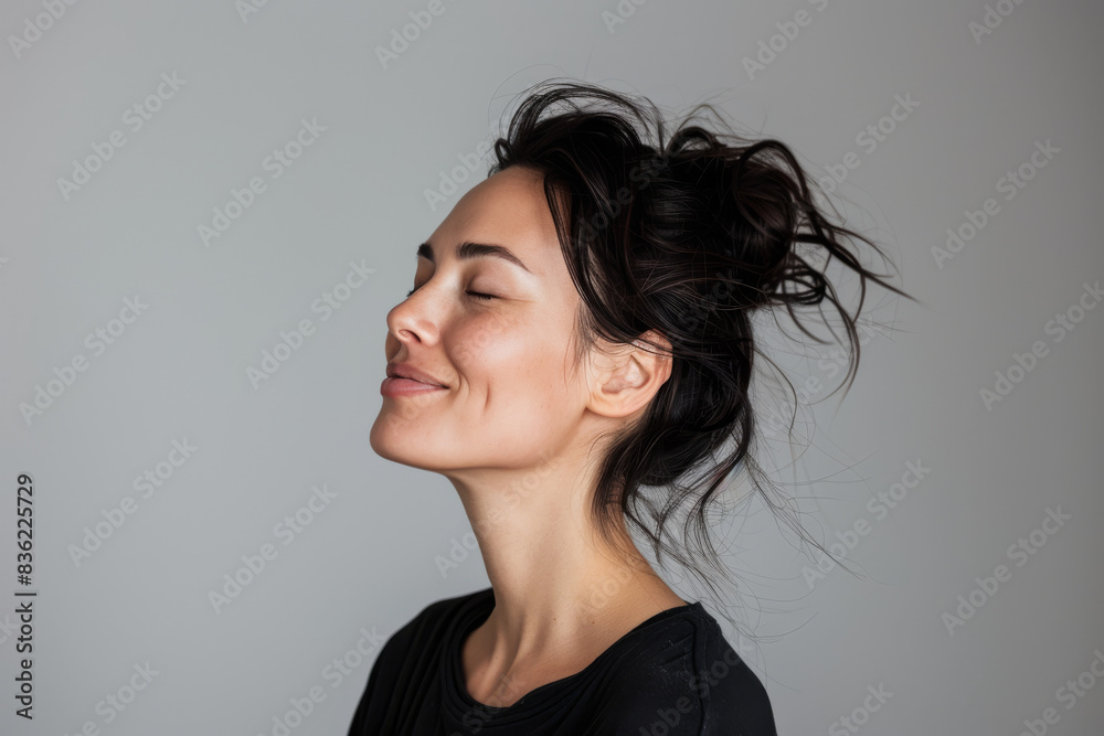 A close up of a woman's face with her eyes closed looking to a side
