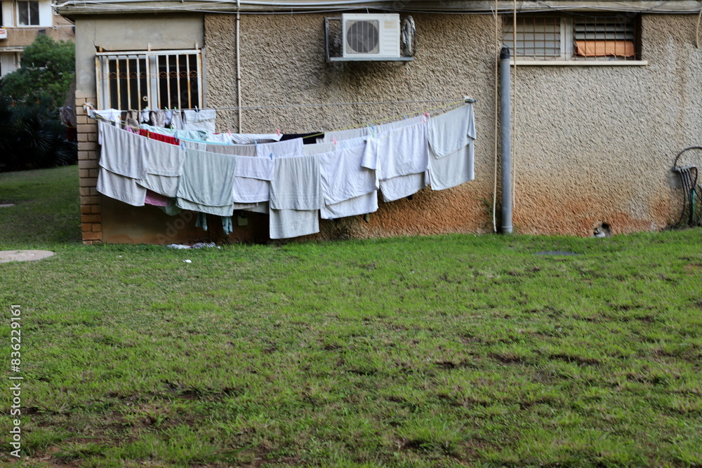 Washed laundry hangs on a rope outside the window. Washed laundry hangs on a rope outside the window.
