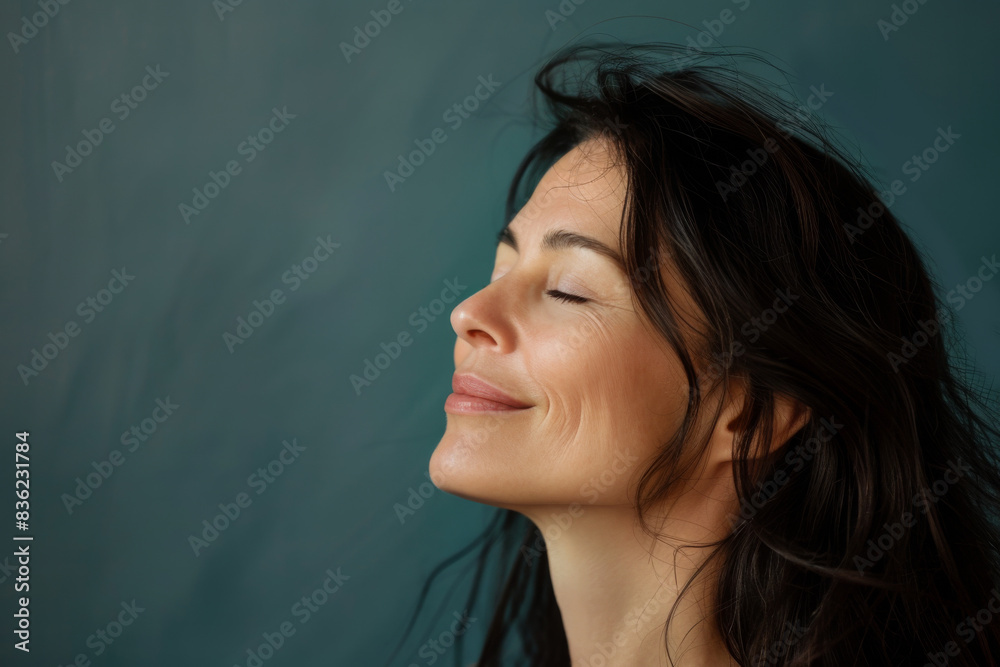 A close up of a woman's face with her eyes closed looking to a side