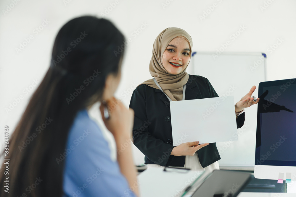 Two professional women discuss and analyze financial data and marketing strategies, presenting and brainstorming to increase company profits. Two professional women discuss and analyze financial data and marketing strategies, presenting and brainstorming to increase company profits.