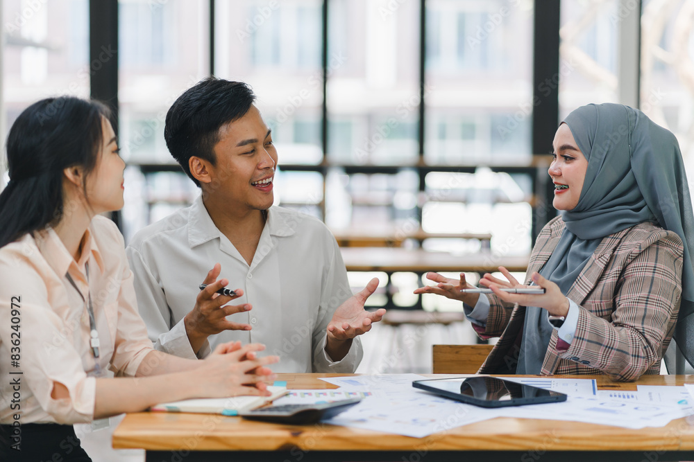 Businesswoman leading a team meeting in an office. Businesswoman leading a team meeting in an office.