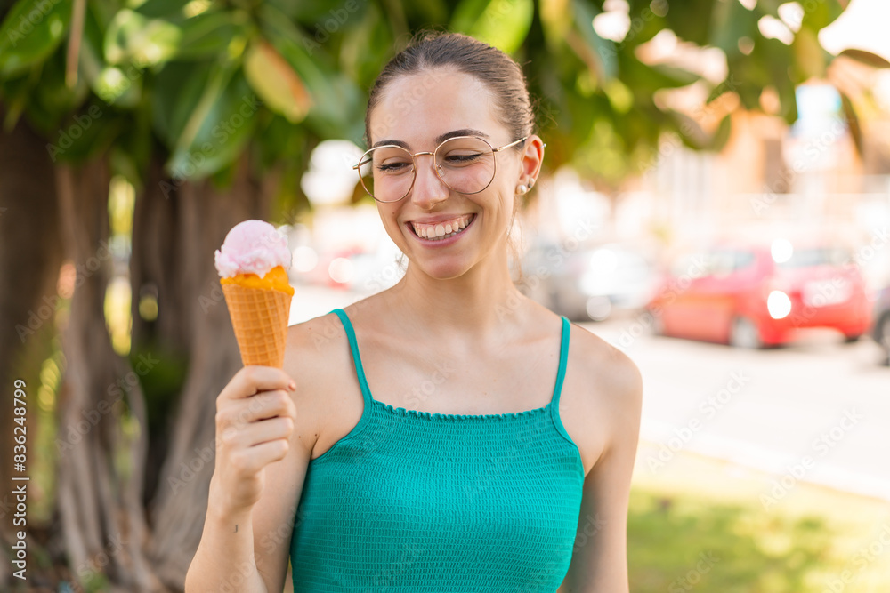 Young pretty woman with a cornet ice cream at outdoors with happy expression Young pretty woman with a cornet ice cream at outdoors with happy expression