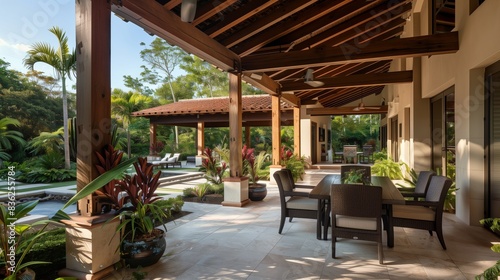 An open-air patio with cedar beams blends into tropical surroundings  creating a space for relaxation.