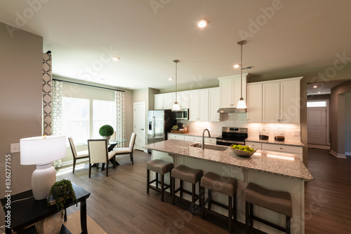 Interior Design of a beautiful modern kitchen with center island. Real estate concept.