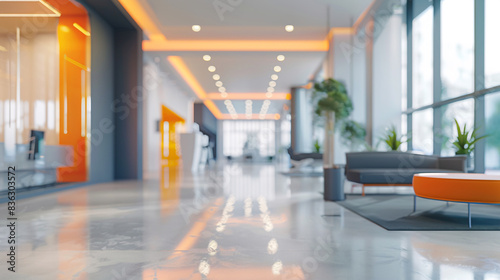 Elegant blurred office interior, gray palette with orange color splashes and wide windows for light