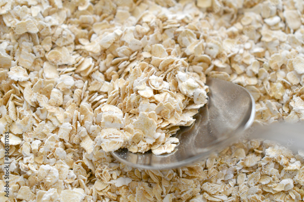 Uncooked oatmeal with spoon. Healthy and dietary food. Uncooked oatmeal with spoon. Healthy and dietary food.