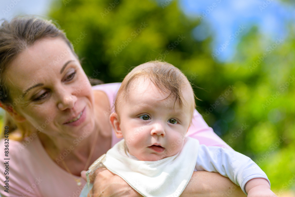Mother Holding Baby Close-Up Outdoors Mother Holding Baby Close-Up Outdoors