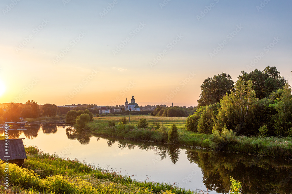 SUZDAL, RUSSIA - Beautiful landscape of Suzdal overlooking the Kamenka River and the ancient Russian Church of Elijah the Prophet (Ilyinsky Church)At sunset SUZDAL, RUSSIA - Beautiful landscape of Suzdal overlooking the Kamenka River and the ancient Russian Church of Elijah the Prophet (Ilyinsky Church)At sunset
