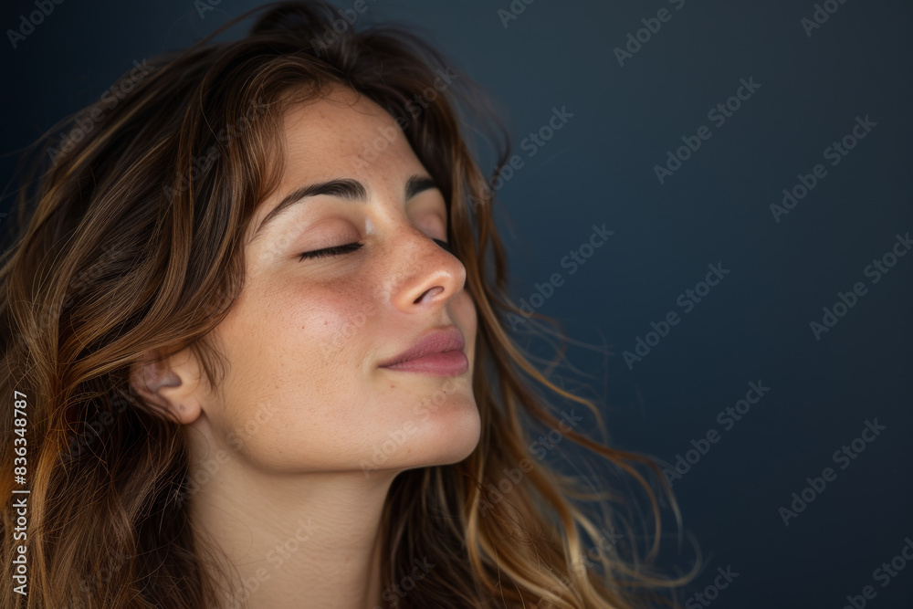 A close up of a woman's face with her eyes closed looking to a side A close up of a woman's face with her eyes closed looking to a side