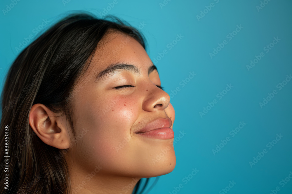 Fototapeta premium A close up of a woman's face with her eyes closed looking to a side
