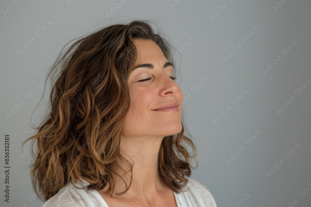 Fototapeta premium A close up of a woman's face with her eyes closed looking to a side