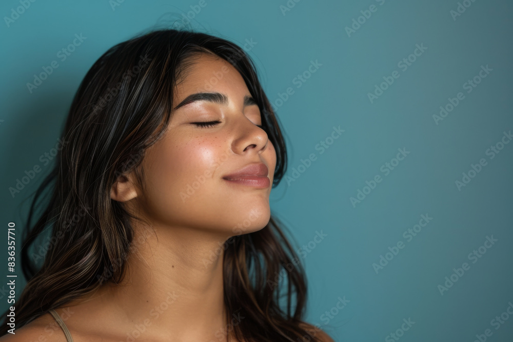 A close up of a woman's face with her eyes closed looking to a side A close up of a woman's face with her eyes closed looking to a side