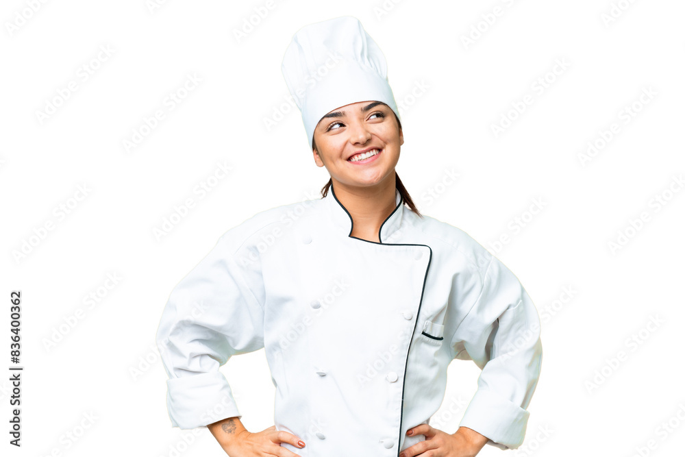 Young woman Chef over isolated chroma key background posing with arms at hip and smiling