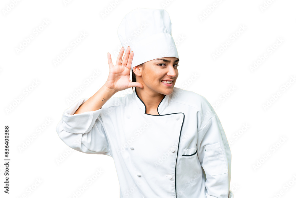 Young woman Chef over isolated chroma key background listening to something by putting hand on the ear Young woman Chef over isolated chroma key background listening to something by putting hand on the ear