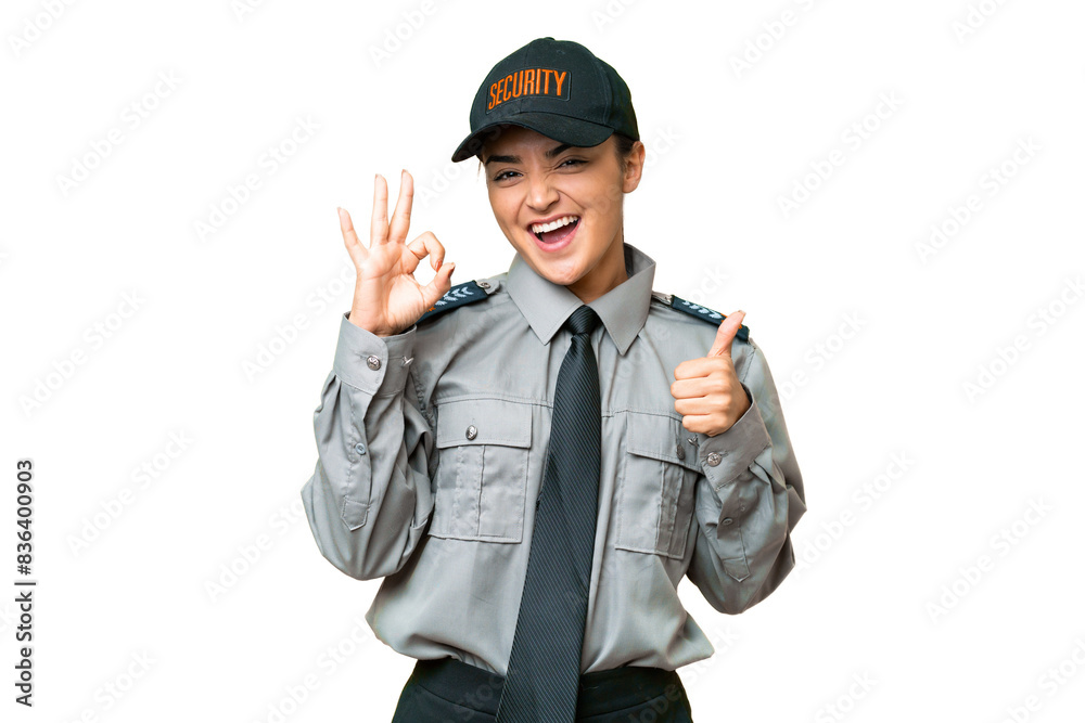 Young safeguard woman over isolated chroma key background showing ok sign and thumb up gesture Young safeguard woman over isolated chroma key background showing ok sign and thumb up gesture