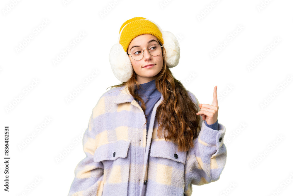 Teenager girl wearing winter muffs over isolated chroma key background showing and lifting a finger in sign of the best Teenager girl wearing winter muffs over isolated chroma key background showing and lifting a finger in sign of the best