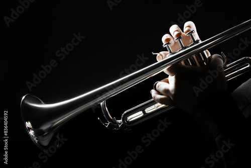 Trumpet player hands playing brass instrument. Jazz musician woman close up