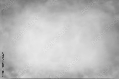 Abstract light grey blurred background. Portrait backdrop for studio. Empty textured wall.