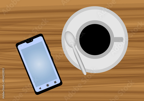 Teléfono móvil y taza de café en una mesa.