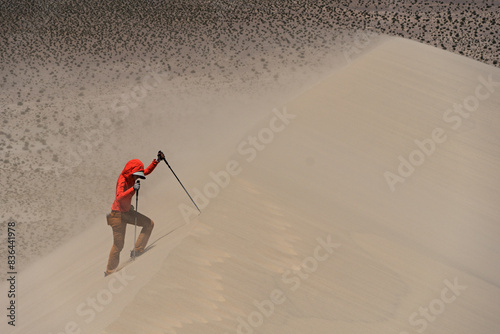 Woman Hiking Up A Sand Dune