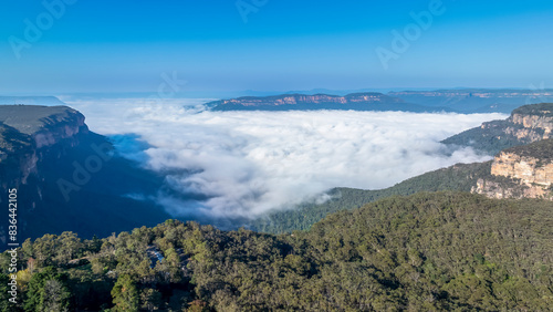 Drone aerial photograph of white fluffy clouds in Jamison Valley near the township of Wentworth Falls in the Blue Mountains in NSW  Australia.