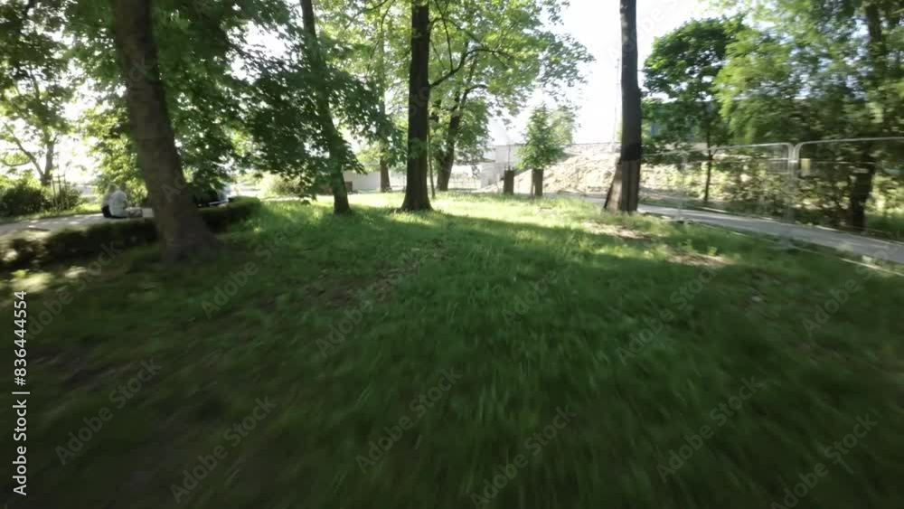 This is a first-person perspective video of a person walking through a park on a sunny day. The video is taken with a GoPro camera mounted on the persons helmet. The video is in 4K resolution and has This is a first-person perspective video of a person walking through a park on a sunny day. The video is taken with a GoPro camera mounted on the persons helmet. The video is in 4K resolution and has