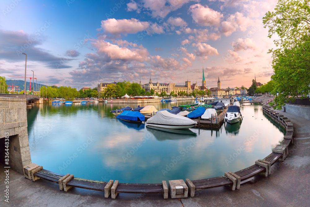 Panoramic view of Fraumunster and St Peters Church with boats docked in Zurich, Switzerland