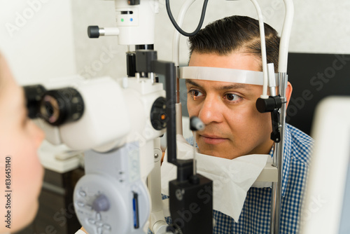 Closeup of a male patient undergoing a vision test performed by an ophthalmologist at a medical clinic