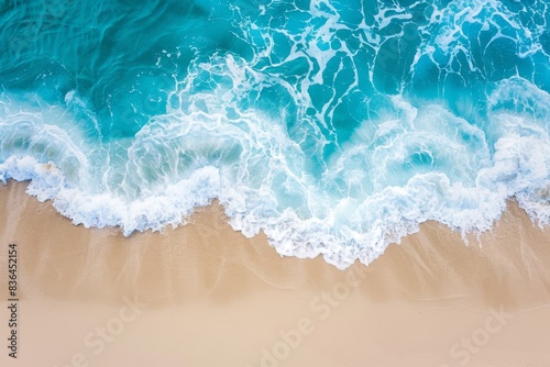 Sandy beach and soft blue ocean wave top view. Summer background