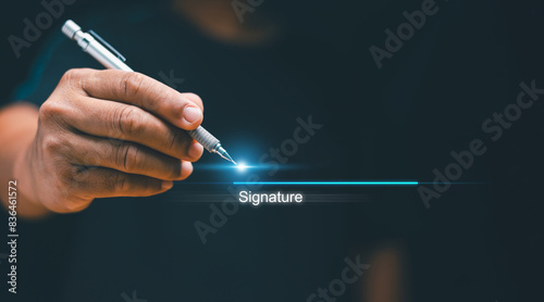 Electronic signature concept, Businessman using pen sign signature on electronic E-signing on virtual screen, Paperless office, Technology for document management, Future business contract signing.