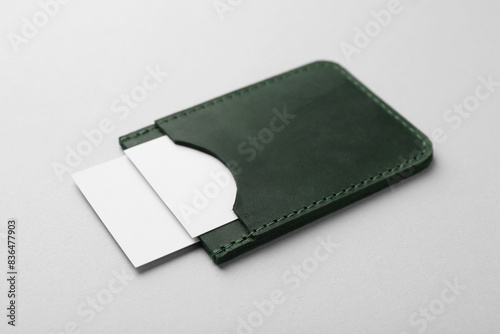 Leather business card holder with blank cards on light grey background