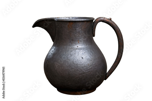 An antique metal pitcher with a rustic appearance isolated on a transparent, white background in png format, illustrating historical kitchenware