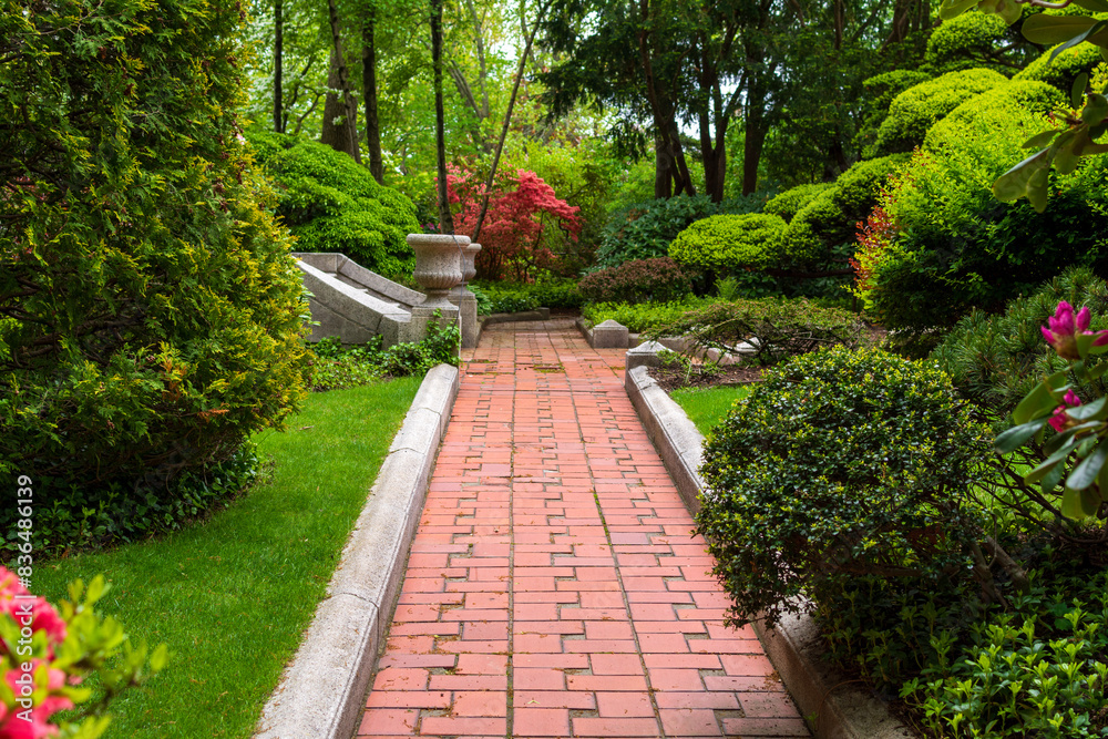 Brick pathway through a serene house garden in Boston, MA, USA Brick pathway through a serene house garden in Boston, MA, USA
