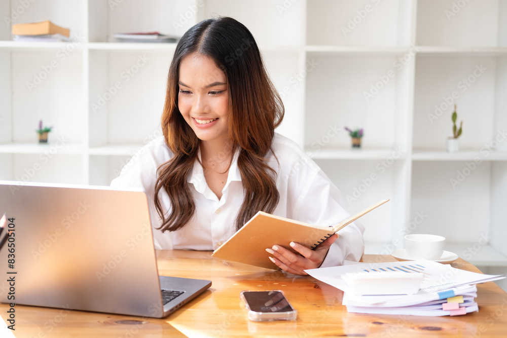 Businesswoman using laptop or notebook computer with data analysis graph dashboard, confident woman working with computer laptop concept, contact idea design dashboard graph business conceptual. Businesswoman using laptop or notebook computer with data analysis graph dashboard, confident woman working with computer laptop concept, contact idea design dashboard graph business conceptual.