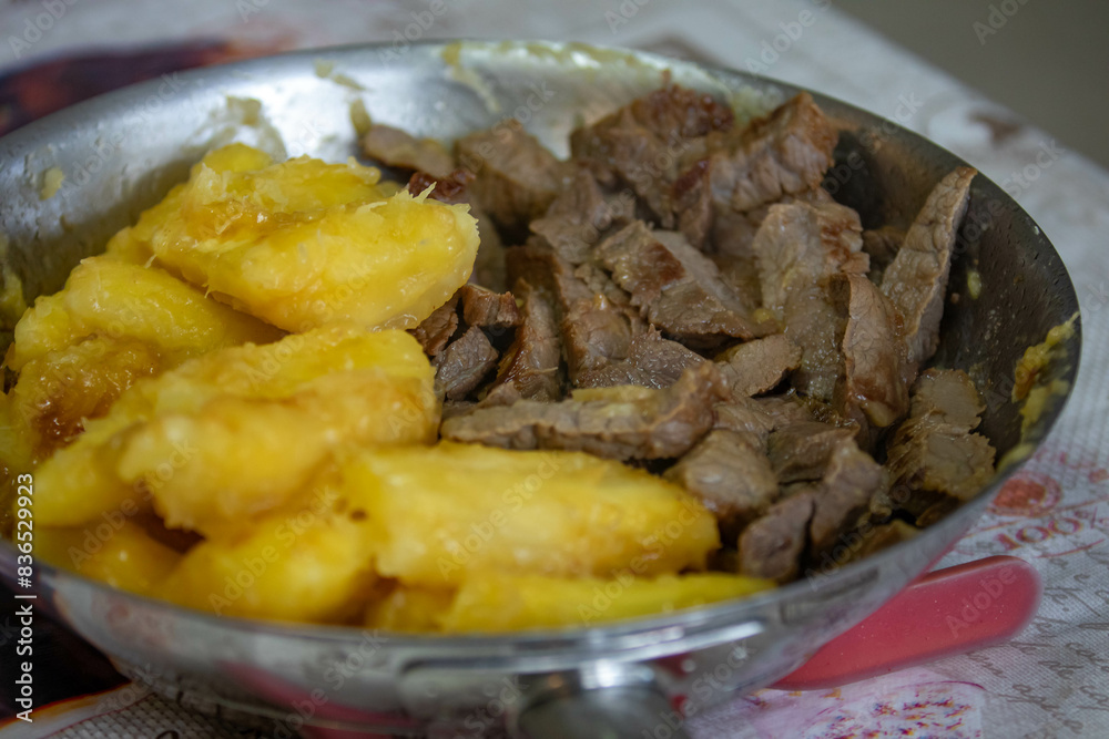 Traditional sun-dried meat with cooked cassava and bottled butter Traditional sun-dried meat with cooked cassava and bottled butter