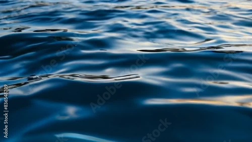 calm blue sea water, calm waves in the ocean. seamless looping overlay 4k virtual video animation background